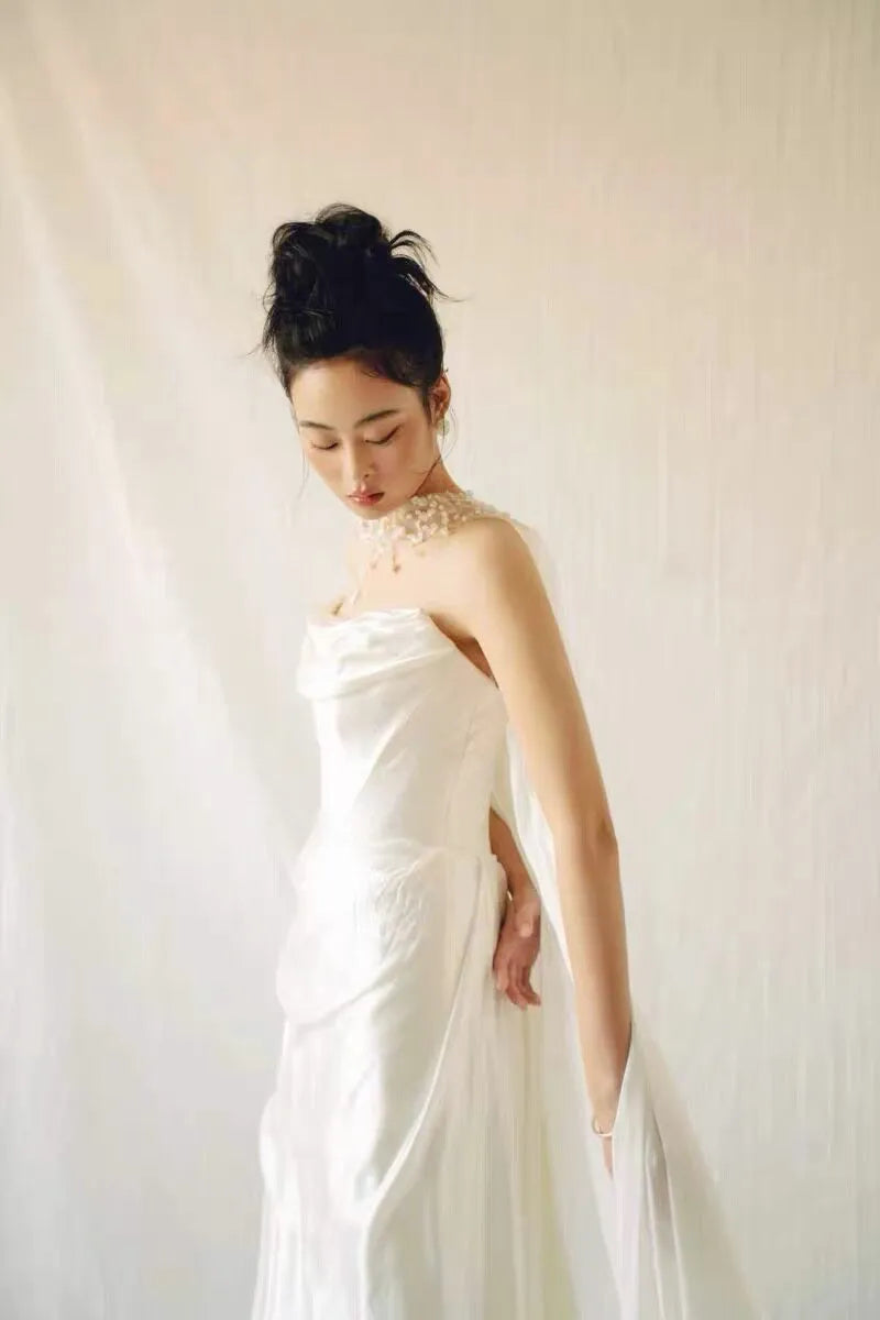 Modern coastal mermaid style halter bridal cape veil featuring exquisite natural seashell embellishments, iridescent mother-of-pearl flakes, and clear glass bead embroidery around the neckline.
