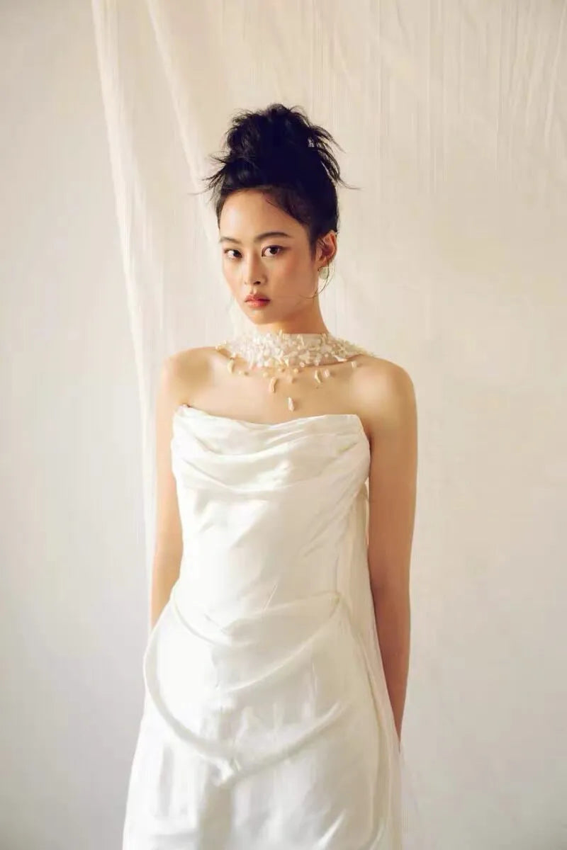 Modern coastal mermaid style halter bridal cape veil featuring exquisite natural seashell embellishments, iridescent mother-of-pearl flakes, and clear glass bead embroidery around the neckline.