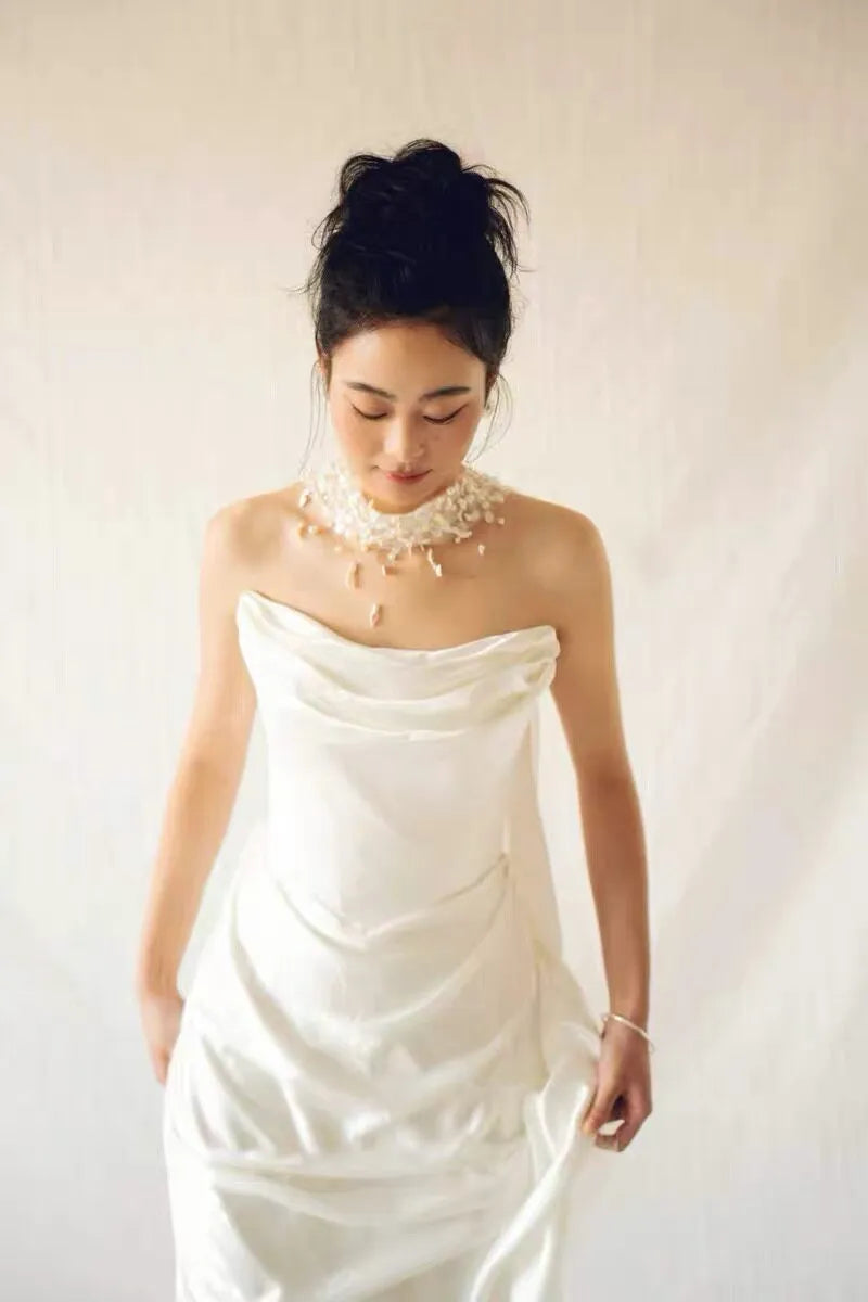 Modern coastal mermaid style halter bridal cape veil featuring exquisite natural seashell embellishments, iridescent mother-of-pearl flakes, and clear glass bead embroidery around the neckline.