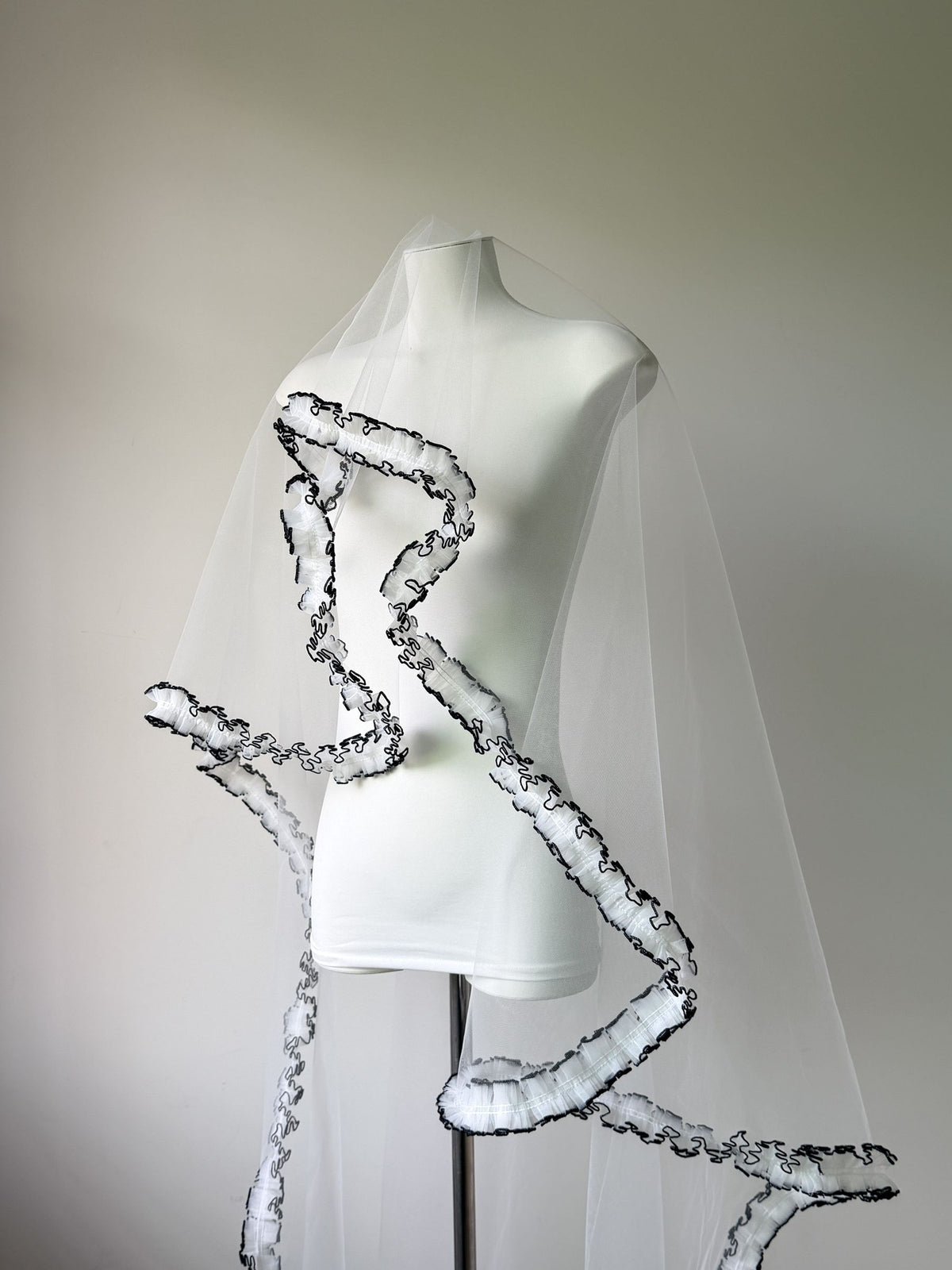 White wedding veil with dramatic black ruffle edge