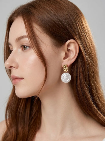 Close-up shot highlighting the molten gold studs and natural coin pearl swirl luster.