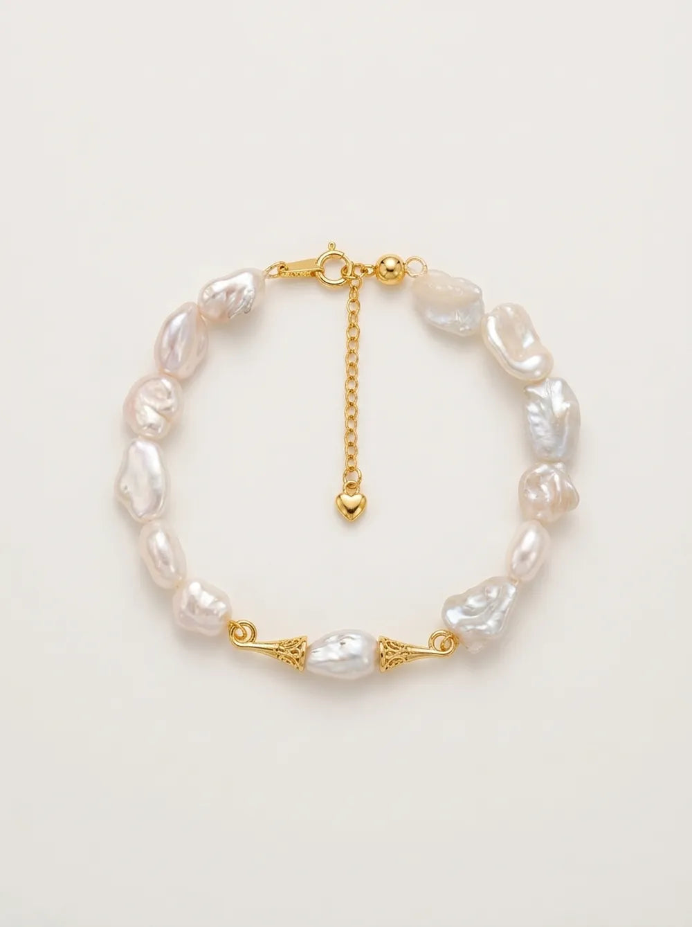 Flatlay view of the circular moustache baroque pearl bracelet with gold S925 silver caps.