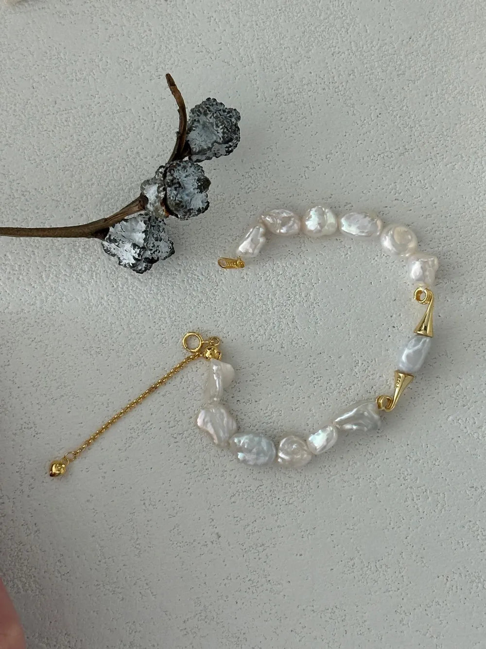 Unclasped view of the moustache baroque pearl strand showing full 15+5cm adjustable length