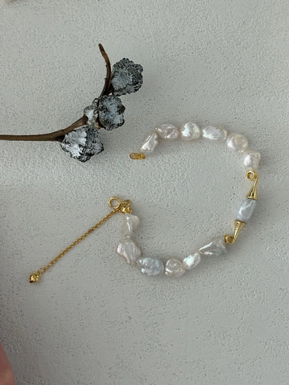 Unclasped view of the moustache baroque pearl strand showing full 15+5cm adjustable length