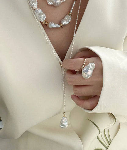 High-fashion multi-layer stack featuring chunky baroque pearl chokers and the Keshi Y-lariat.   