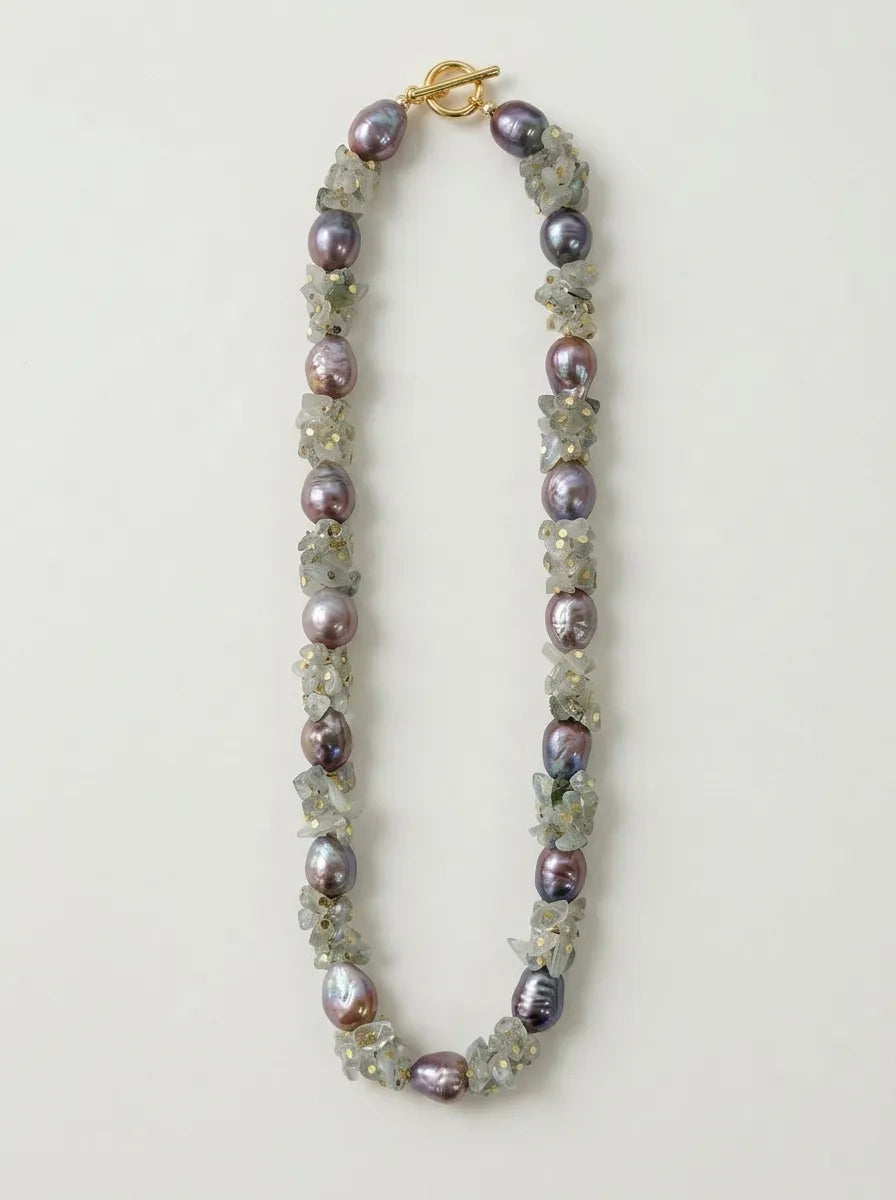 Straightened flatlay view of moonstone chip and purple baroque pearl necklace with OT clasp.
