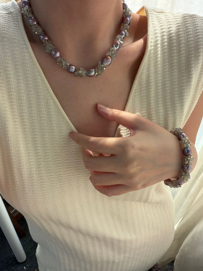 Model wearing natural moonstone and purple baroque pearl necklace with matching bracelet.