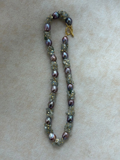 Vertical S-curve layout of natural moonstone and purple baroque pearl necklace.
