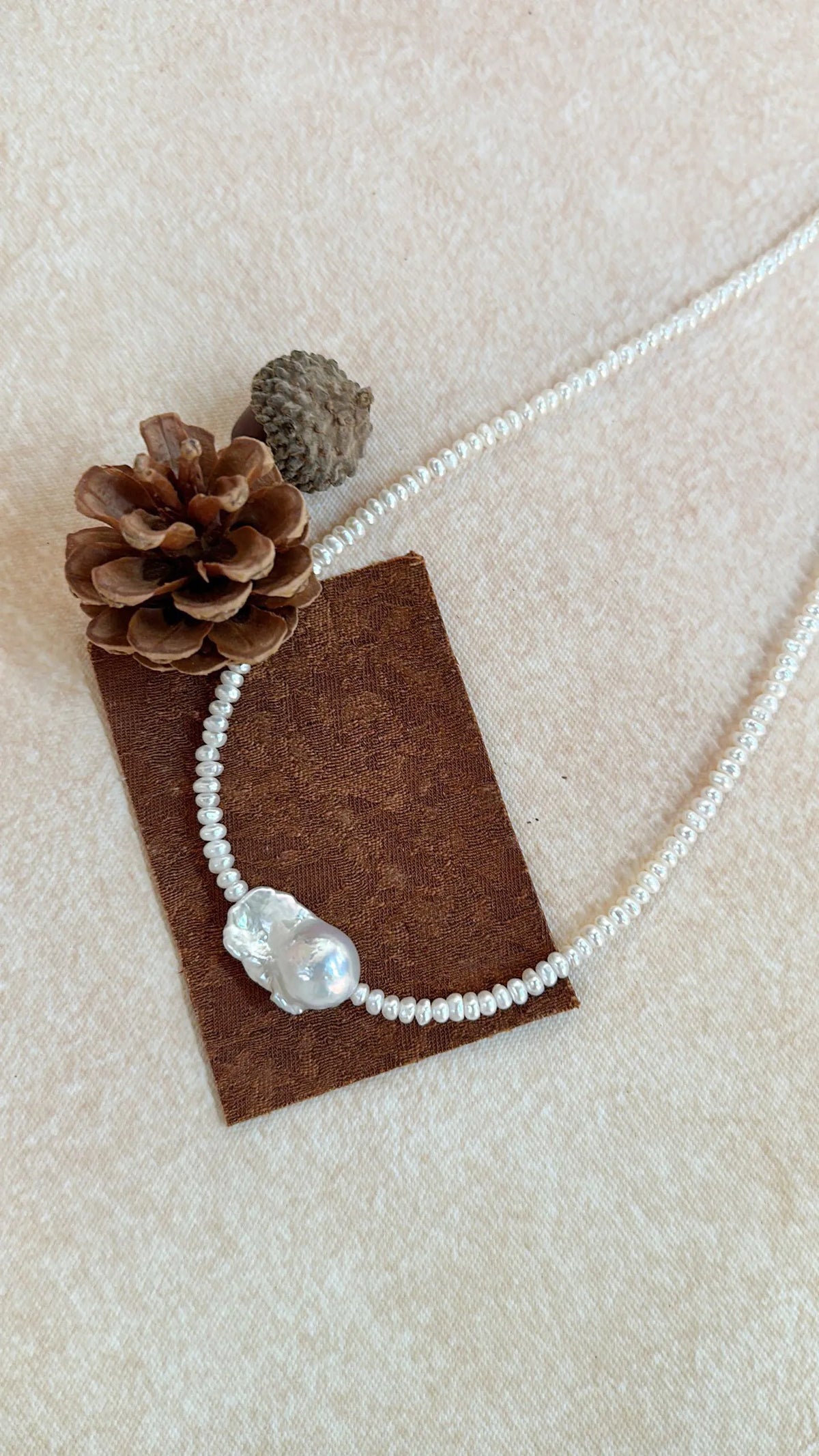 Detailed close-up of the natural luster and organic texture of the baroque pearl center.