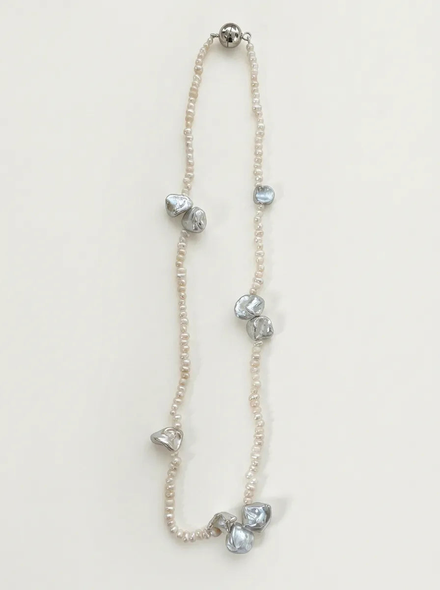 Full view of 40cm organic petal freshwater pearl necklace with silver magnetic clasp on white background