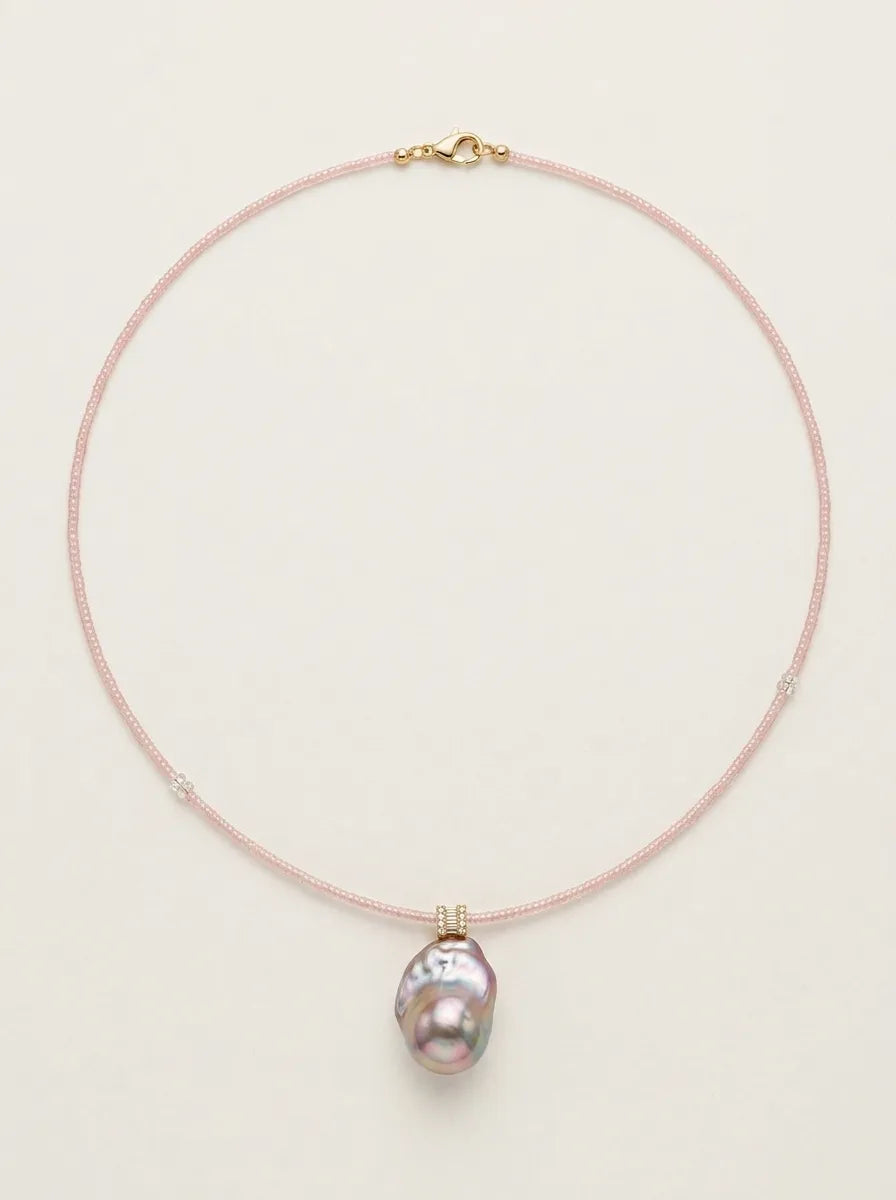 Full view loop shot of the pink beaded baroque pearl necklace against light background.