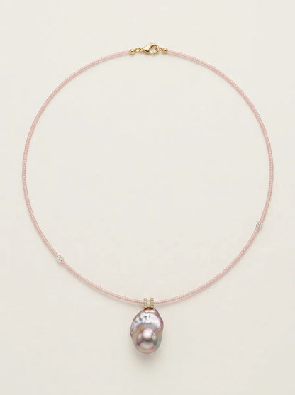 Full view loop shot of the pink beaded baroque pearl necklace against light background.
