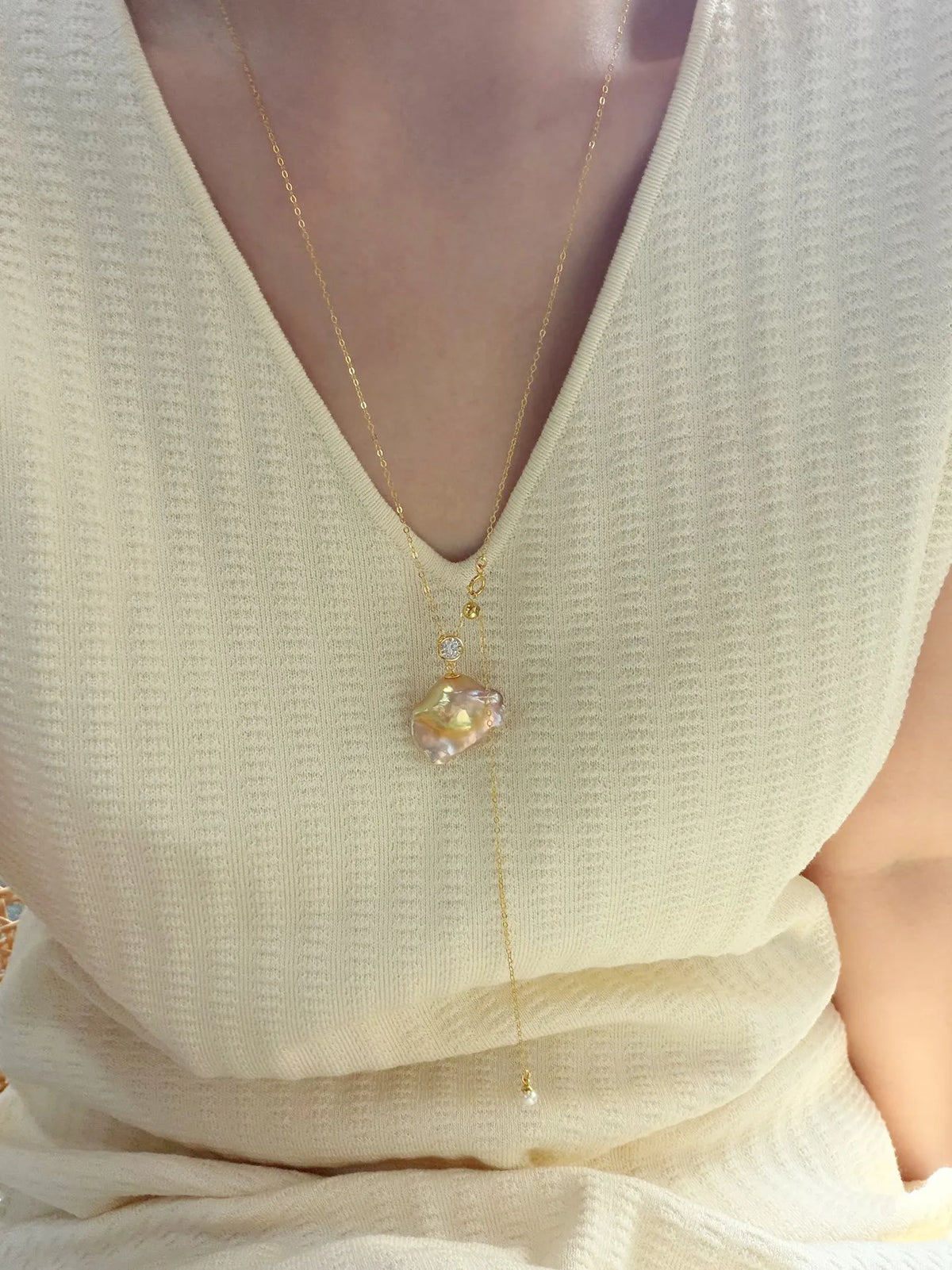 Model wearing 65cm adjustable rainbow baroque pearl long necklace styled as a Y-lariat.