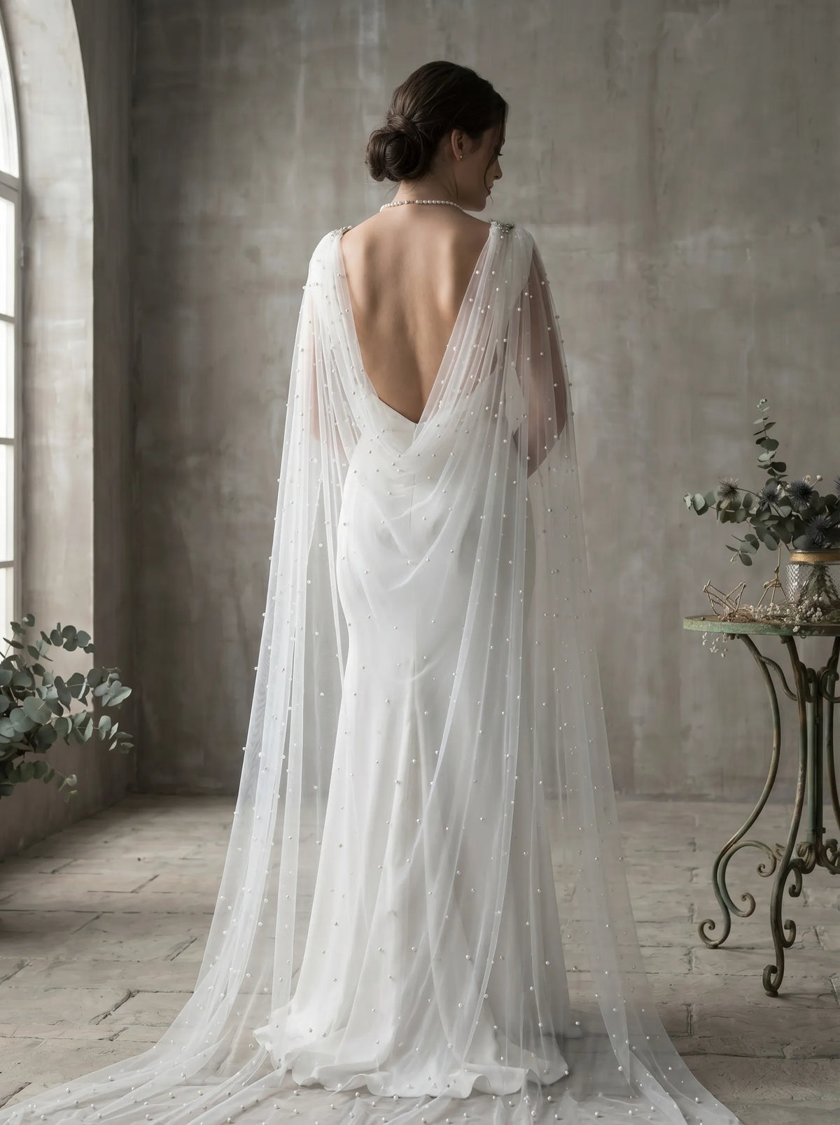 Wide cathedral bridal cape flowing behind wedding dress