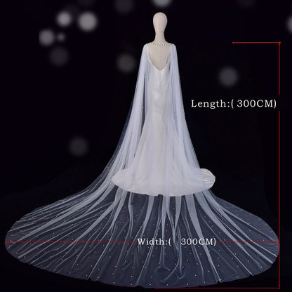 Wide cathedral bridal cape flowing behind wedding dress