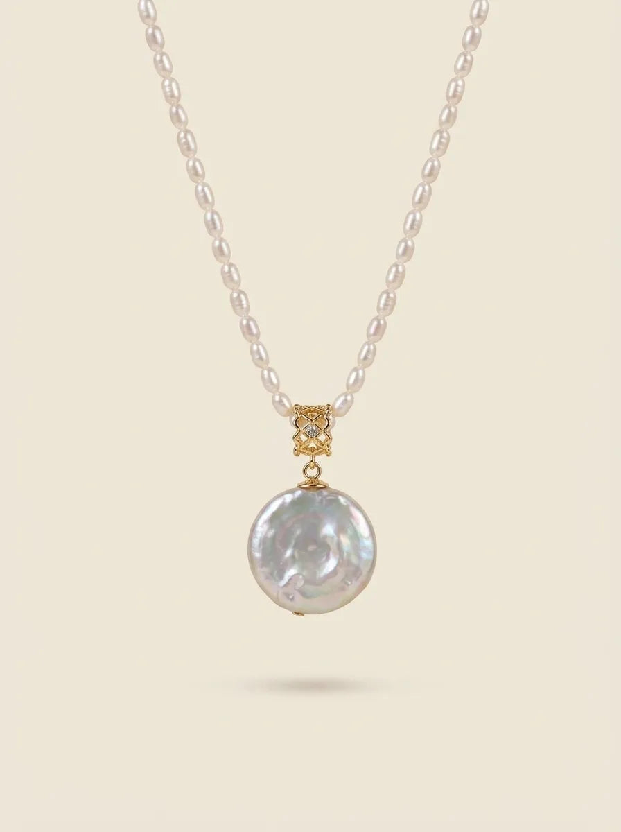 Studio product shot of the Roman coin freshwater pearl pendant with 18K gold plated bail.