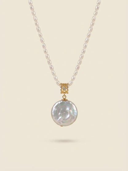 Studio product shot of the Roman coin freshwater pearl pendant with 18K gold plated bail.