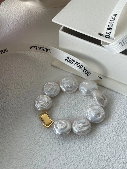 Roman Holiday coin baroque pearl bracelet displayed beside a white gift box and printed ribbon.