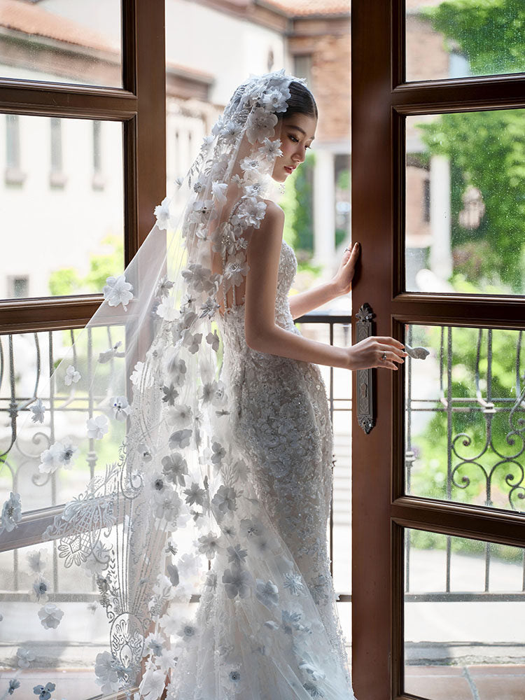 Close up of three dimensional flowers on a bridal cathedral veil