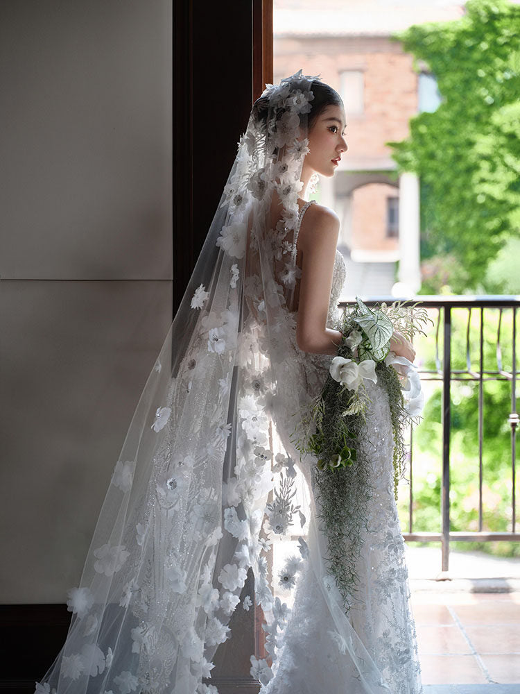 Close up of three dimensional flowers on a bridal cathedral veil