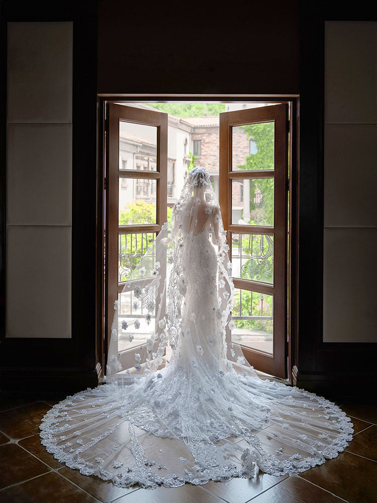 Close up of three dimensional flowers on a bridal cathedral veil