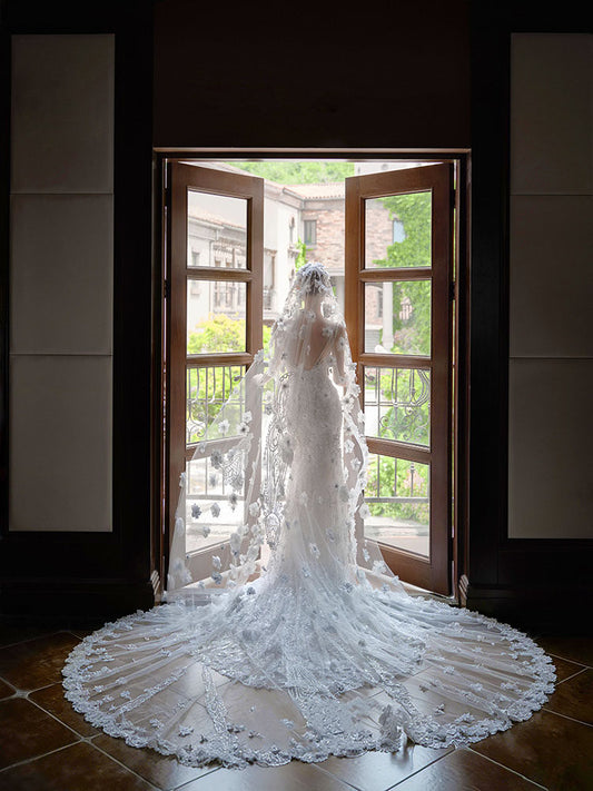 Close up of three dimensional flowers on a bridal cathedral veil