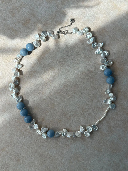 Circular display of blue gemstone petal pearl necklace showcasing S925 silver extender chain