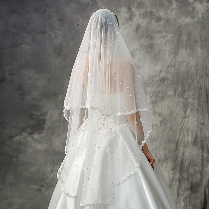 Elegant bride wearing romantic pearl wedding veil