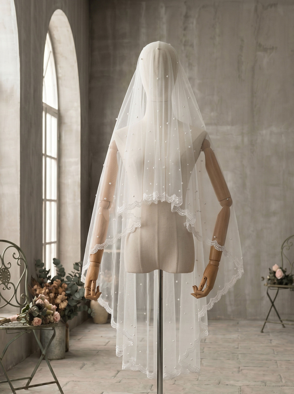 Close up of pearl details on soft tulle bridal veil
