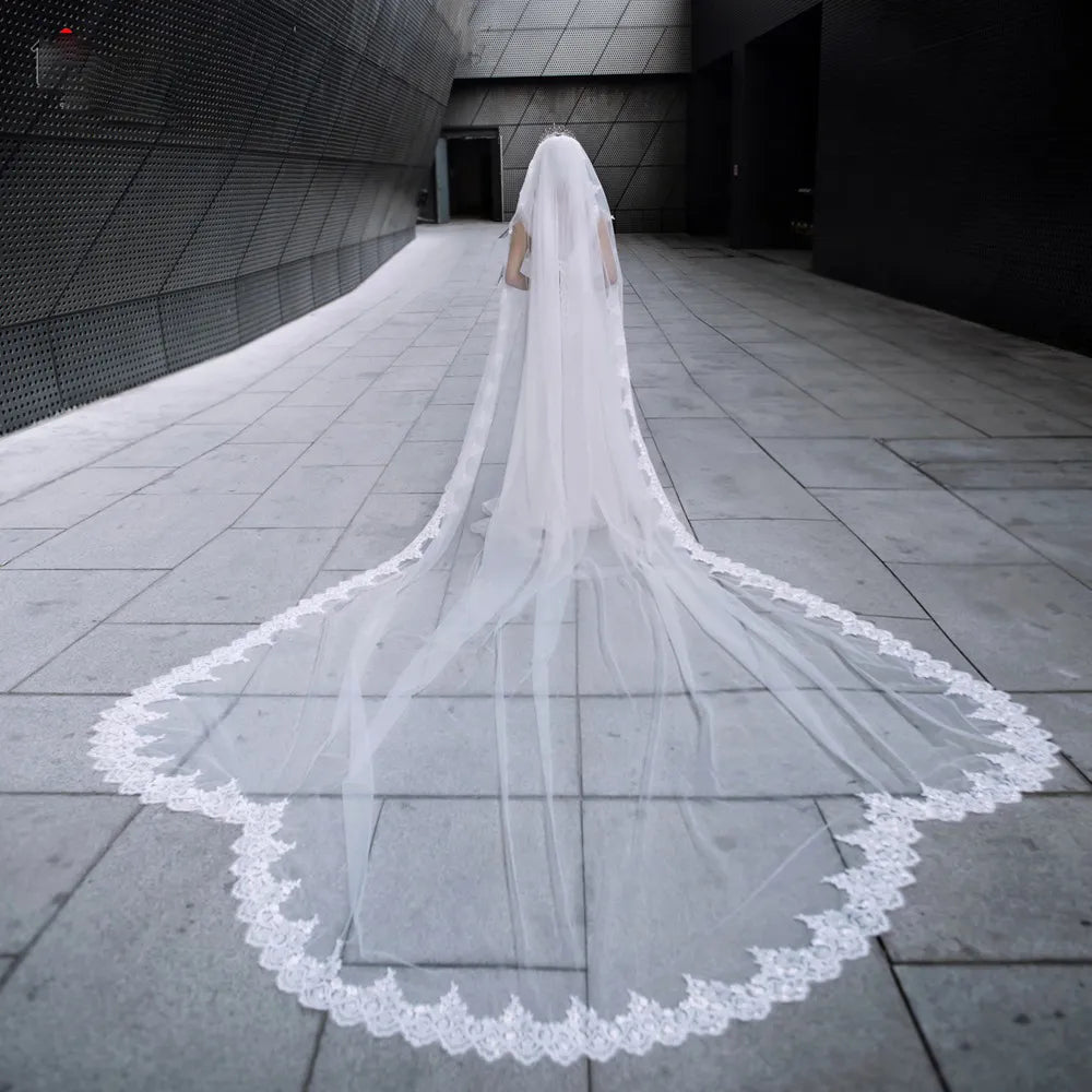 Rear view of bride walking down modern stone aisle wearing 300cm sequin lace cathedral veil