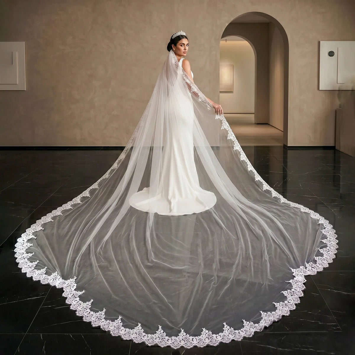 Full view of bride standing in archway with 400cm wide sequin lace cathedral veil fully spread out