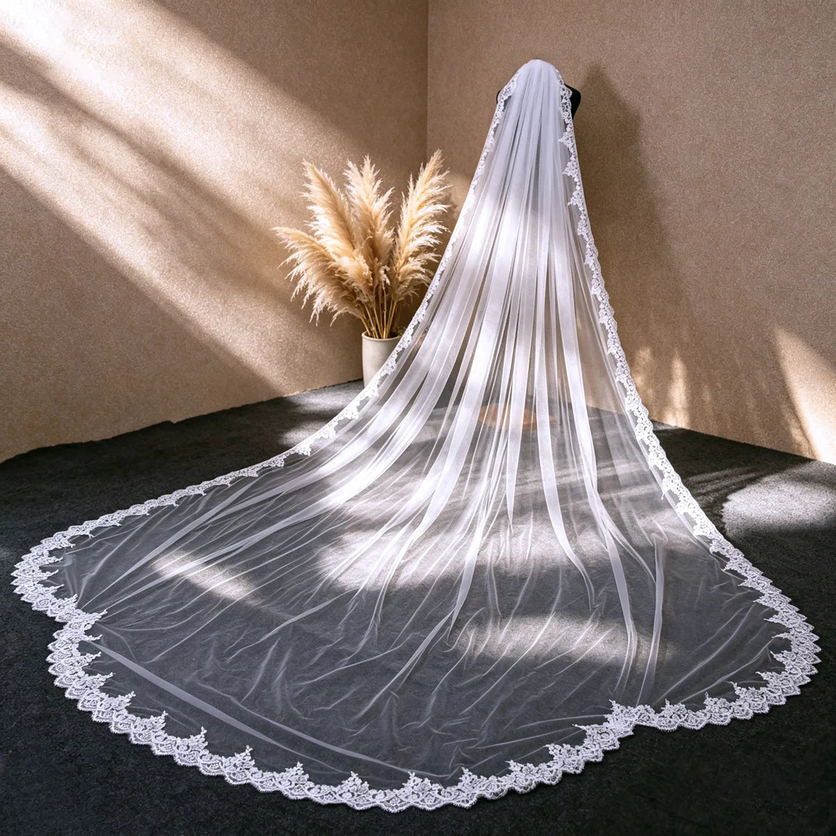 Studio dress form mannequin displaying 300cm sequin lace cathedral veil under warm lighting