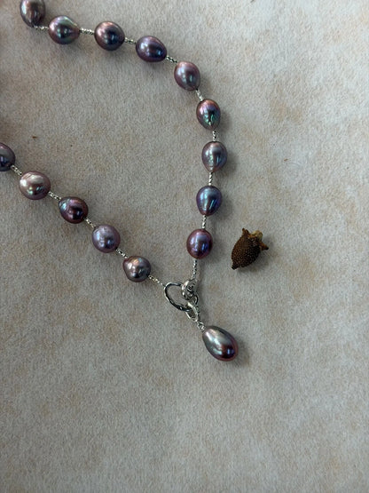 Close-up view of S925 sterling silver front clasp with detachable teardrop baroque pearl pendant.