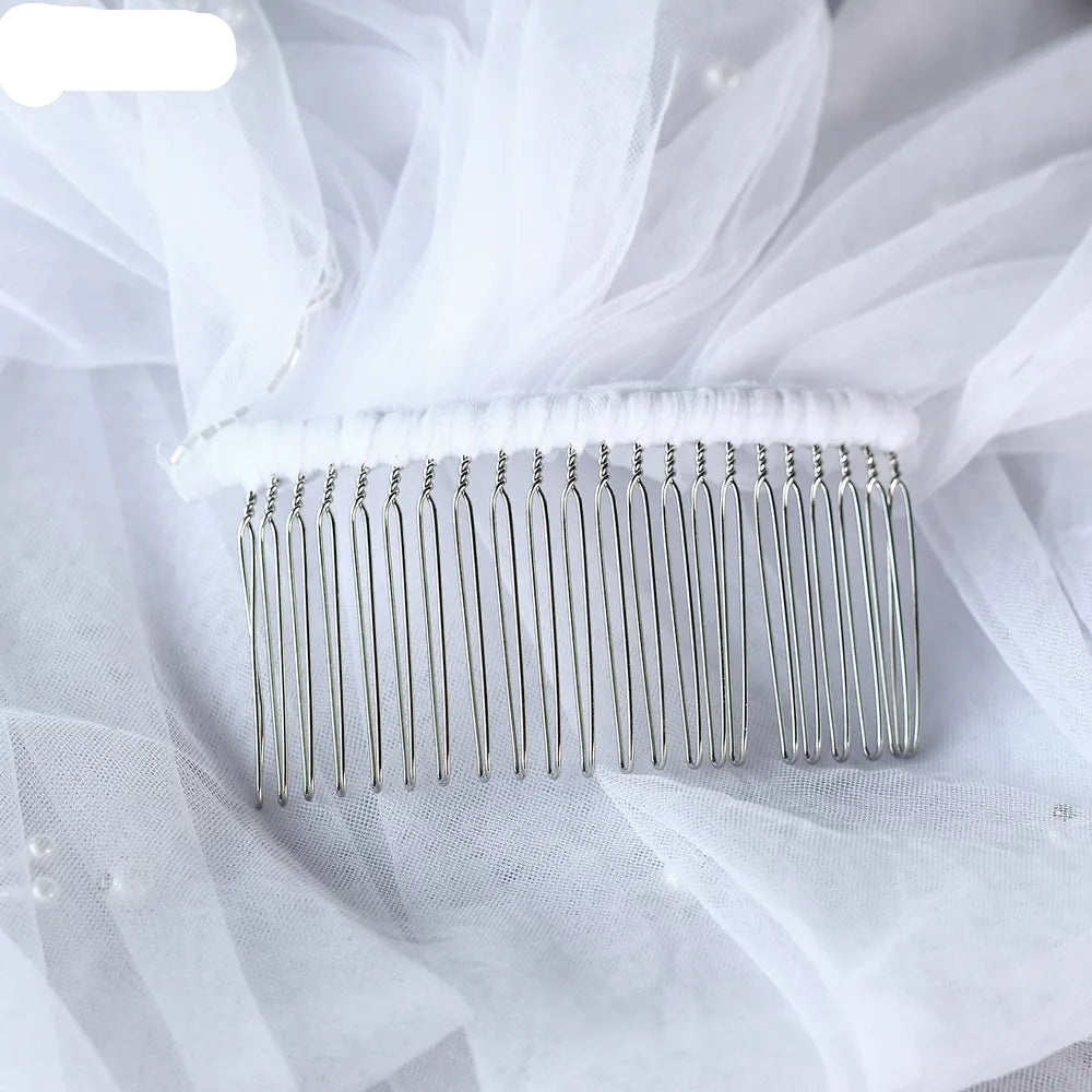 Close-up view of sturdy metal comb wrapped securely in soft white tulle for comfortable placement