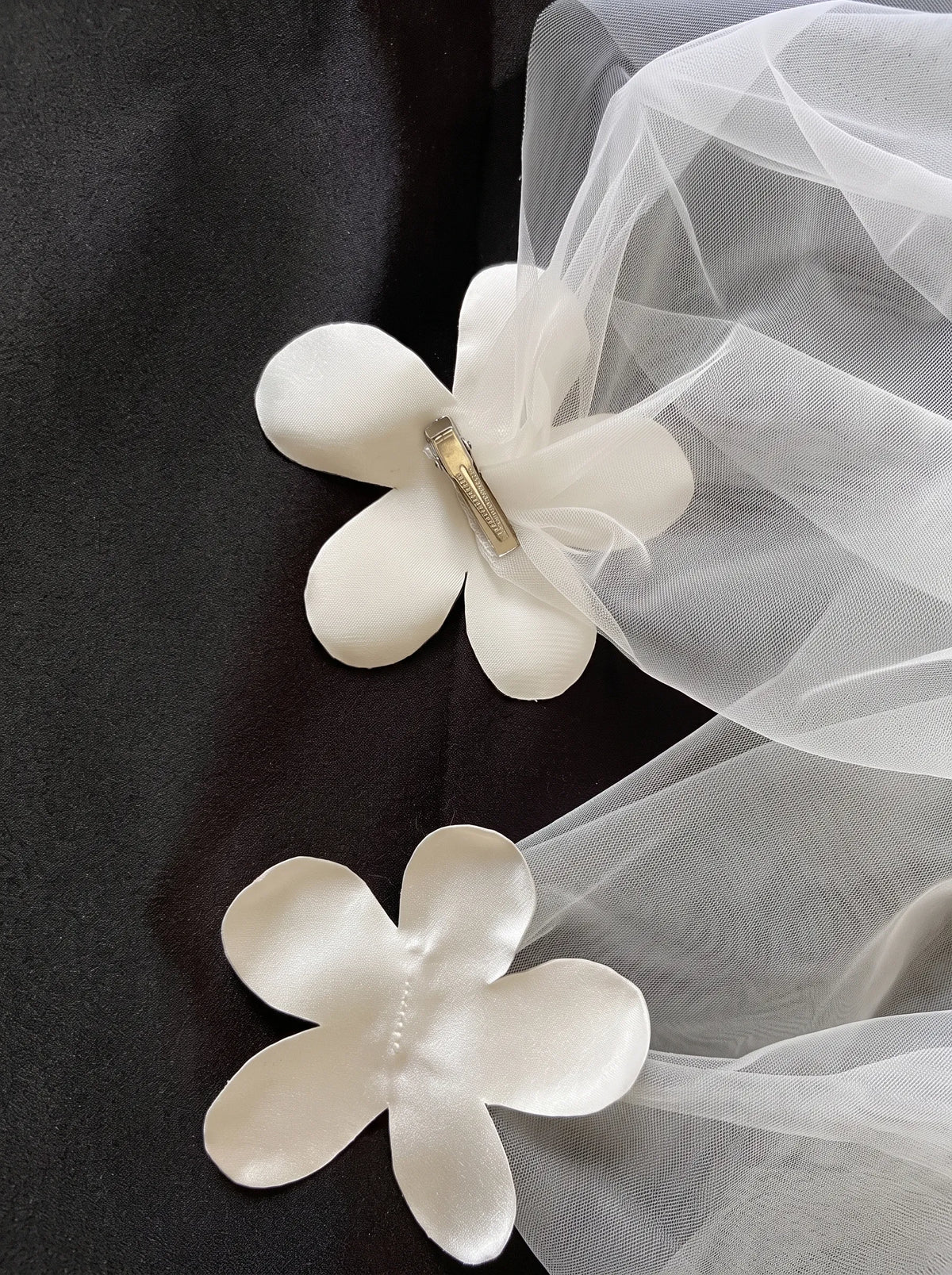 Modern minimalist single-tier cathedral length bridal veil made of high-density soft tulle, attached with handcrafted 3D white satin flower alligator clips.