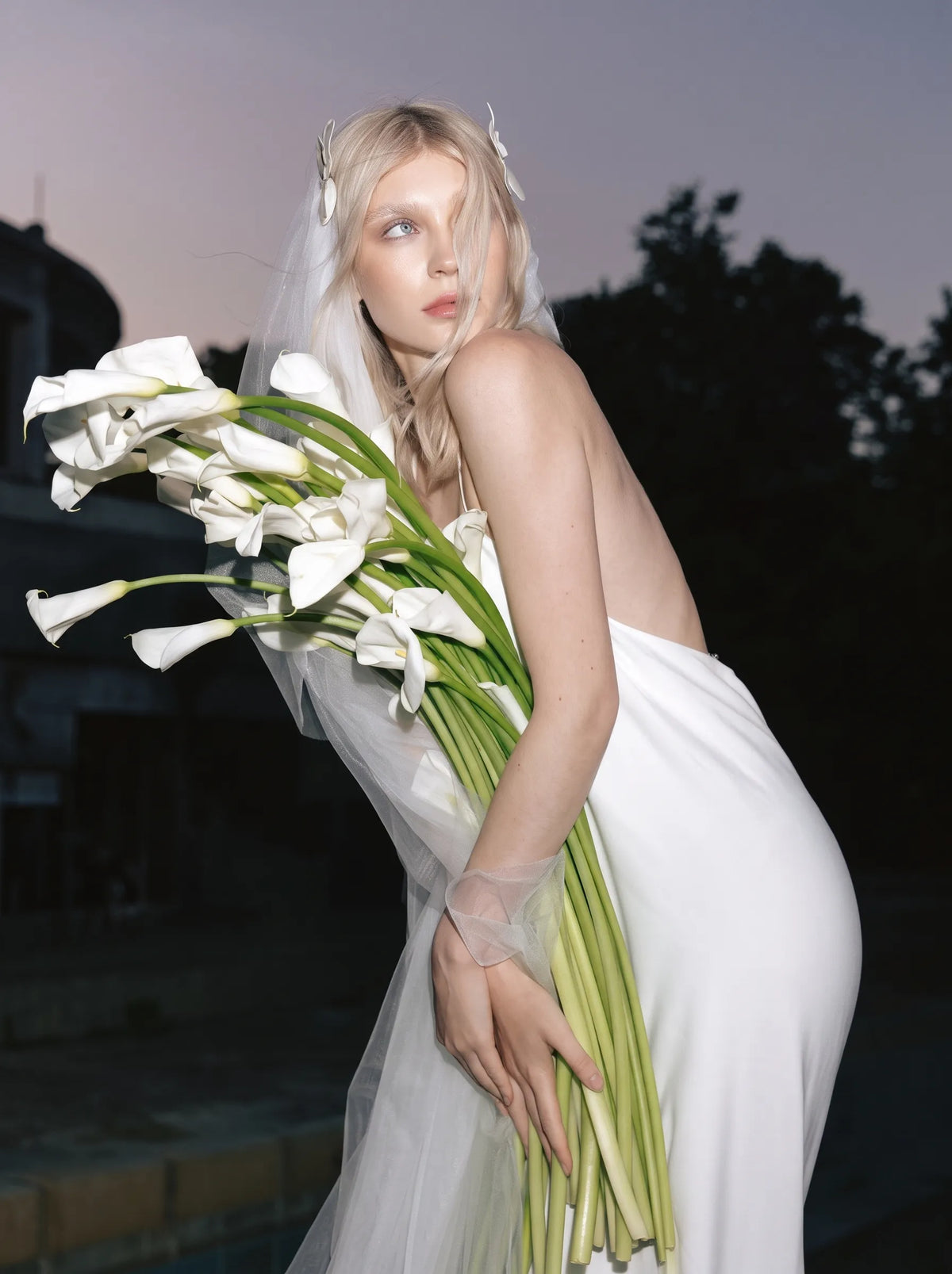 Modern minimalist single-tier cathedral length bridal veil made of high-density soft tulle, attached with handcrafted 3D white satin flower alligator clips.