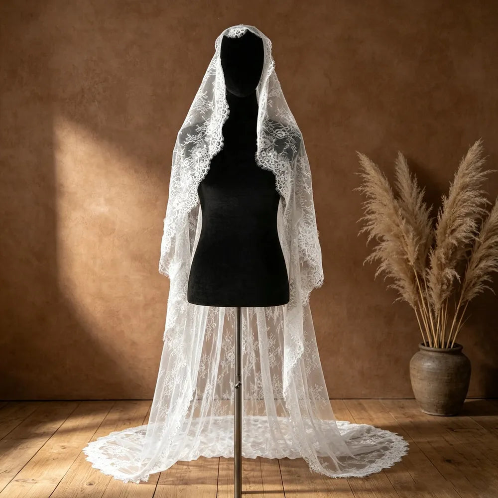 Mannequin display showing the full 300cm length of the mantilla lace wedding veil flowing gracefully onto a wooden floor