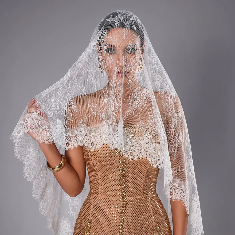 Extreme close-up shot highlighting the intricate Chantilly eyelash lace border and scalloped trim along the bridal veil edge