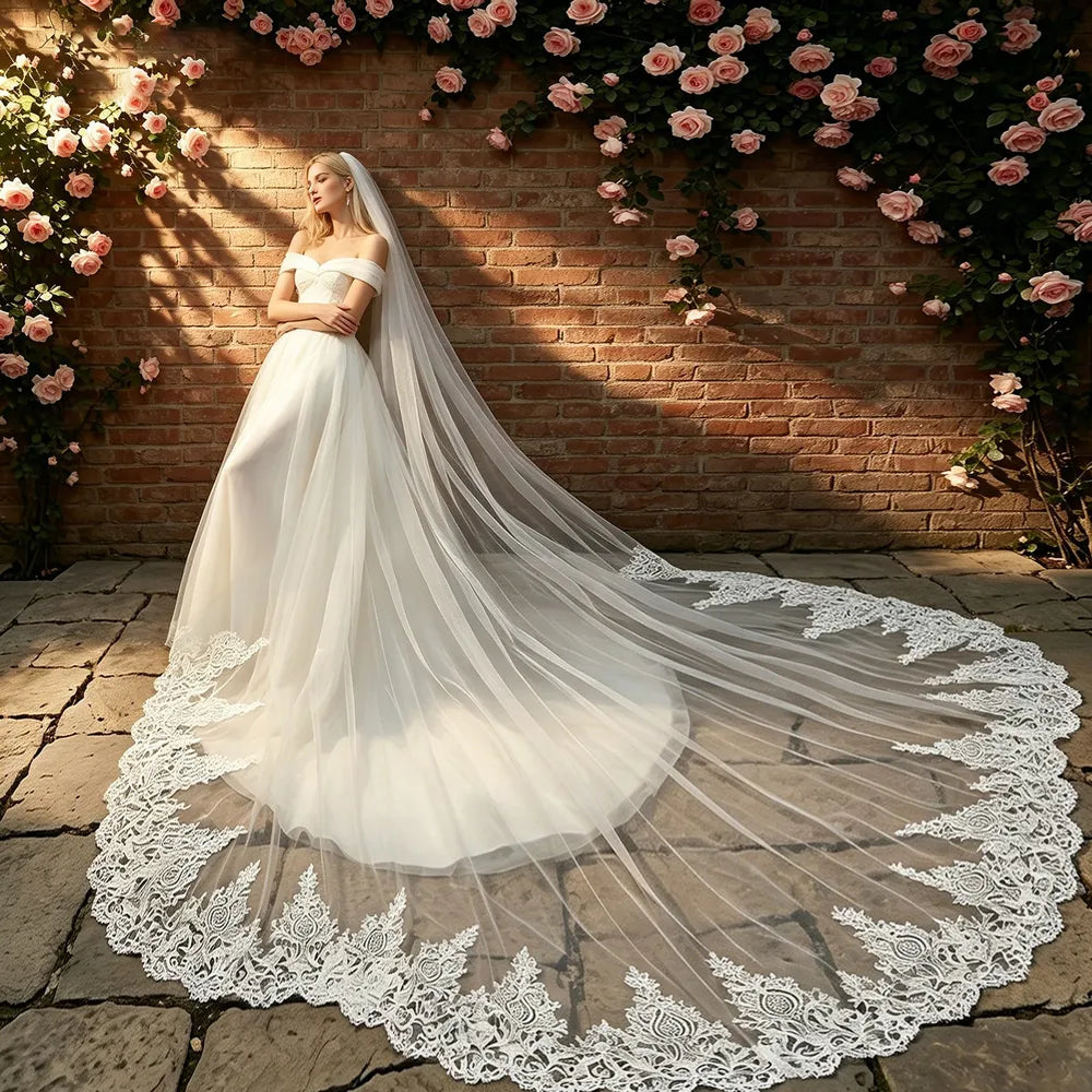 Bride in off-the-shoulder mermaid gown seated with 400cm cathedral lace veil spread gracefully across the floor