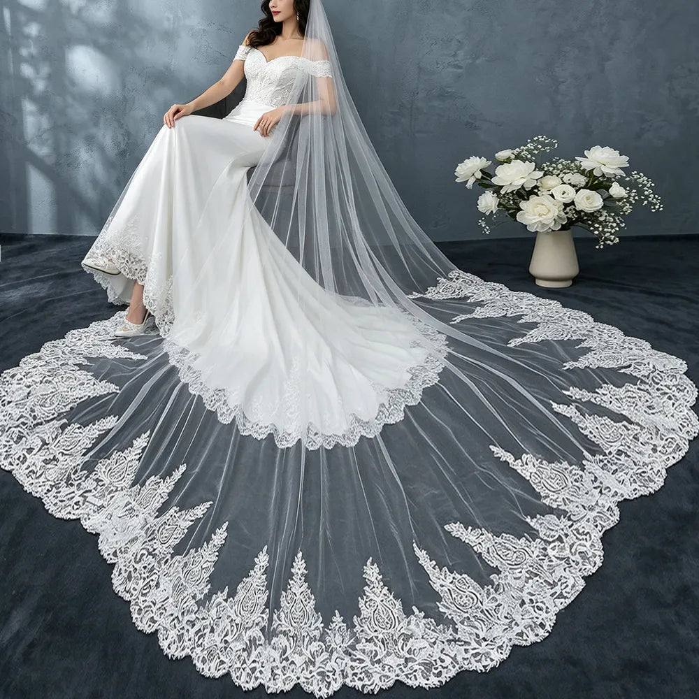 Macro close-up shot showing delicate Baroque floral embroidered lace appliques along scalloped veil hem