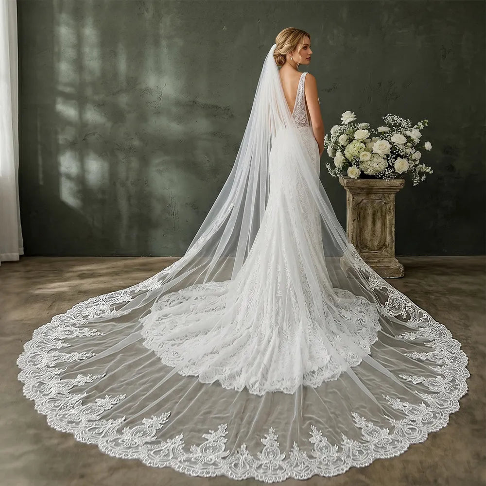 Side view of bride in strapless gown with 300cm single-tier cathedral lace veil flowing smoothly behind her