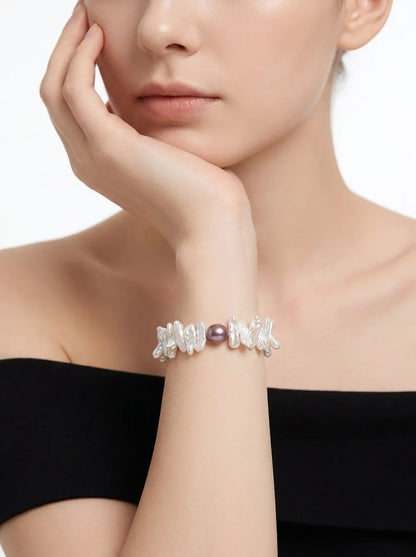 Model wearing the Size S stick baroque pearl elastic bracelet on wrist paired with an off-shoulder outfit.
