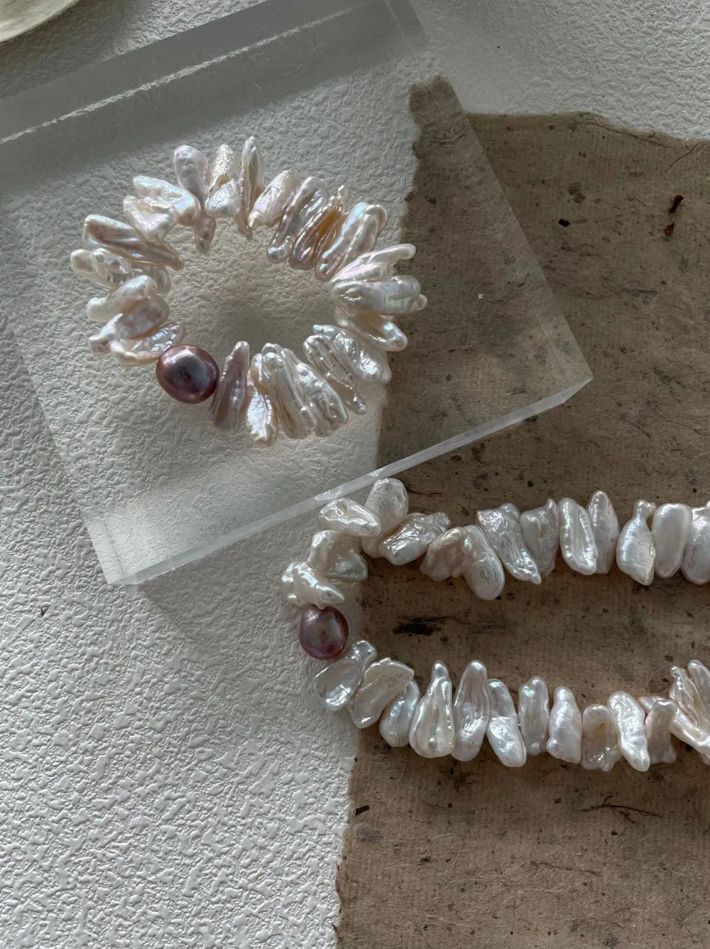 Overhead shot of the natural stick baroque pearl elastic bracelet highlighting organic textures.