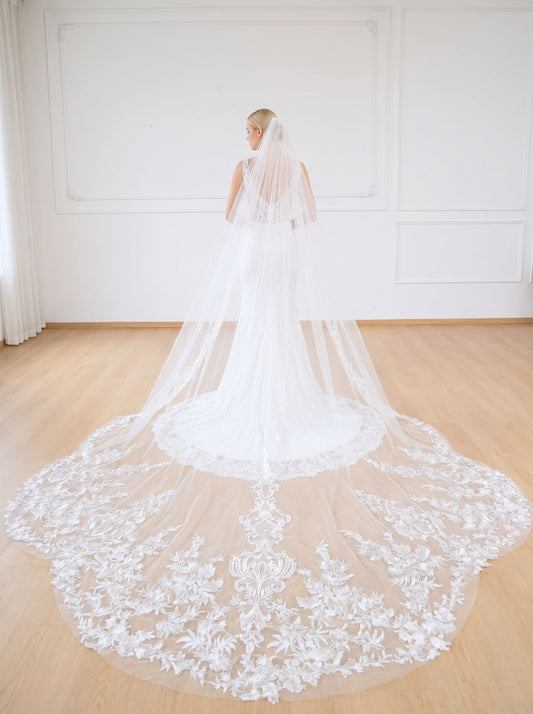 Ultra long cathedral tulle wedding veil decorated with symmetrical elaborate 3D floral lace embroidery on wide train