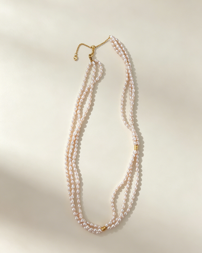 Three delicate strands of freshwater pearls create a softly layered necklace, finished with refined 18K gold-plated silver details.