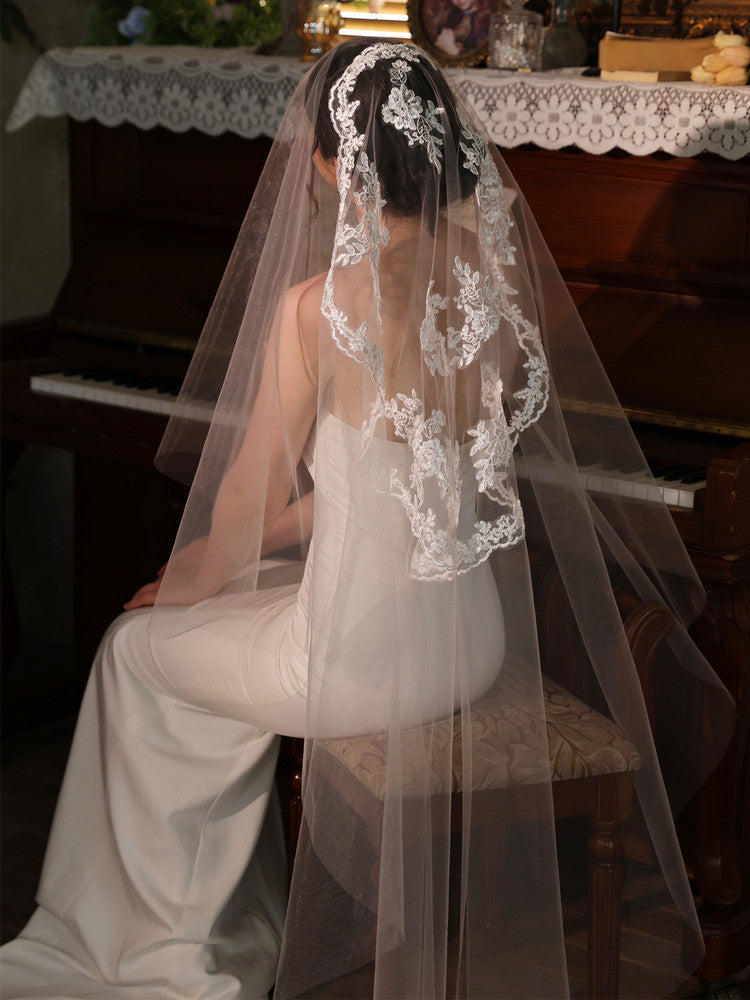 Off-white 2m two tier mid-length bridal veil with hair comb and floral lace applique trim
