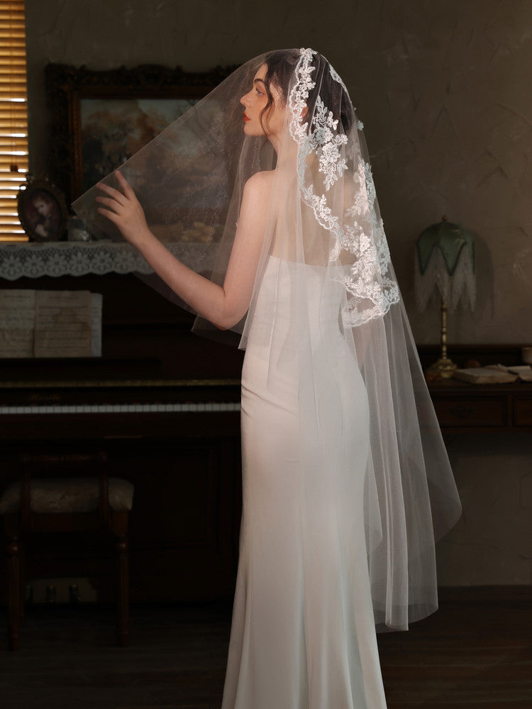 Off-white 2m two tier mid-length bridal veil with hair comb and floral lace applique trim
