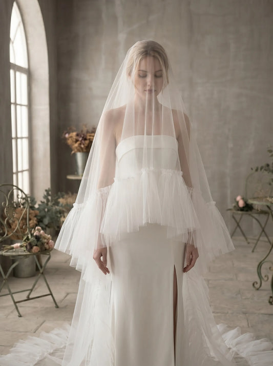 Elegant two-tier long cathedral tulle veil decorated with soft ruffled edge for bride wedding ceremony