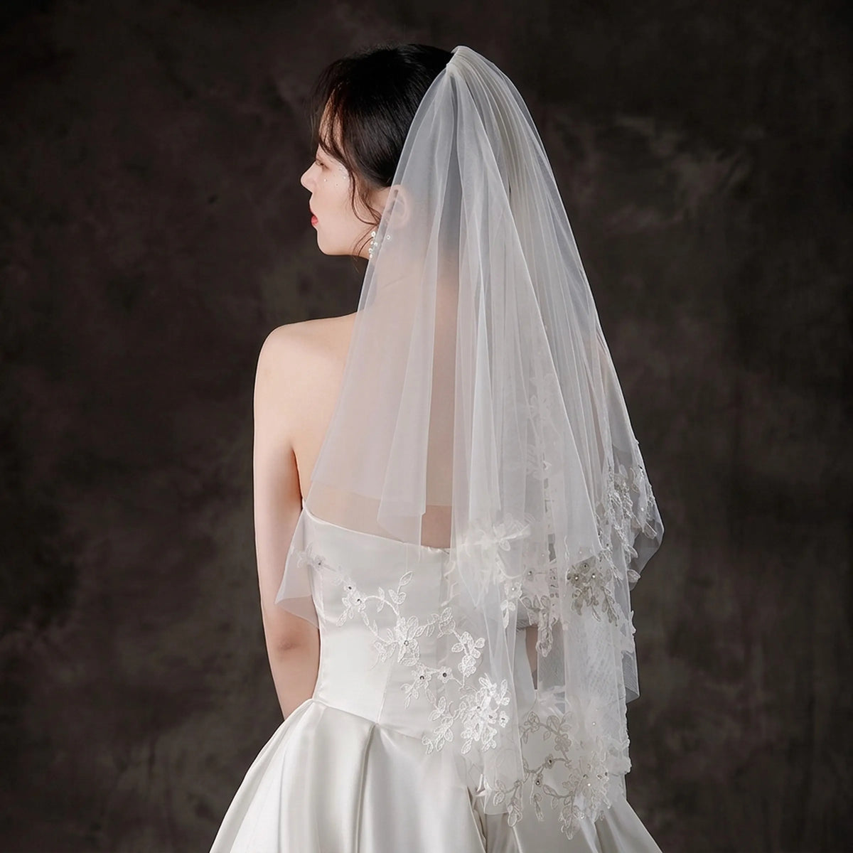 bride wearing a short two tier floral wedding veil